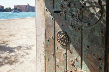 Antique iron door opens to the Grand canal, Venice, Italy