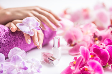 Beautiful nail manicure with decoration from pink orchid