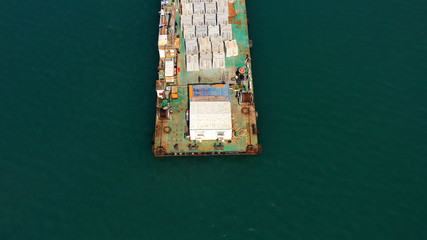 Fototapeta na wymiar Drone view over Large barge with construction materials in Mediterranean sea new Harbor