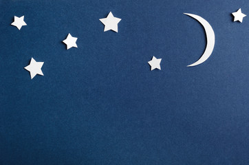 Moon and stars on blue background top view. Night sky objects with shadow close up. Decorative...