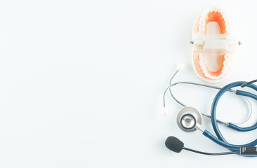 Dental model with stethoscope on white background in dental care concept.