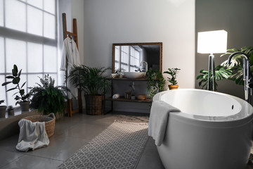 Stylish interior of bathroom at night