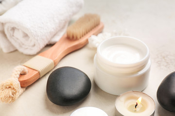 Fototapeta na wymiar Cosmetic cream with spa items on light background