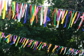 Colorful ribbons blowing in the wind around the big tree during Festival. Meditation and tranquility