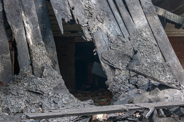 fire aftermathBurnt boards from a collapsed roof during a fire. Fire aftermath