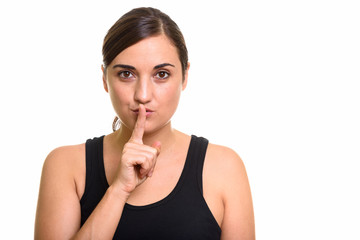 Studio shot of beautiful woman with finger on lips