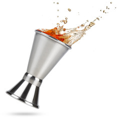 liquor spilling out of a tilted jigger isolated on white background
