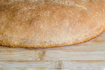 Fresh homemade whole-grain crispy bread. On a cutting board. Healthy eating concept. Close-up. Copy space