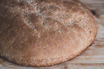 Fresh, whole-wheat crisp bread. On a dark wooden surface. Healthy eating concept. Close-up