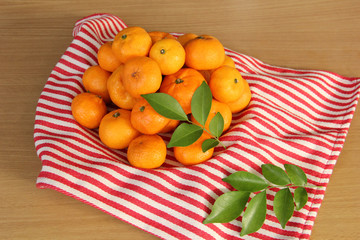 Miniature mandarin orange on a wooden table.