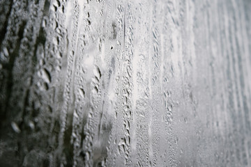 wet drips of rain on the window. Sadness, sad mood