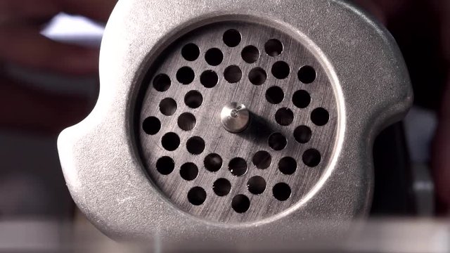 Close up shot of electic meat grinder mincing raw meat. Electrical devices for cooking.