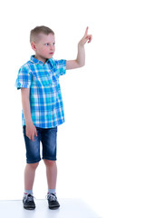 The boy points a finger at something.