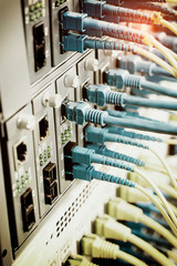 Fiber Optic cables connected to an optic ports and Network cables connected to ethernet ports
