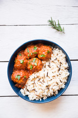 Meatballs with rice and tomato sauce in a bowl