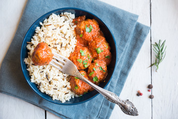 Meatballs with rice and tomato sauce in a bowl