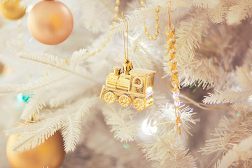 Christmas-tree decoration (golden train) on white christmas tree © O l g a