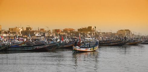 Fishing boats in  Senegal, called pirogue or piragua or piraga - obrazy, fototapety, plakaty