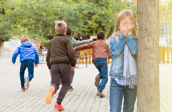 Teenage playing hide-and-go-seek in the playground