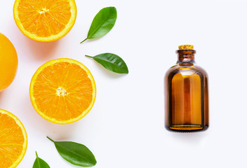 Citrus essential oil with fresh orange fruit isolated on white