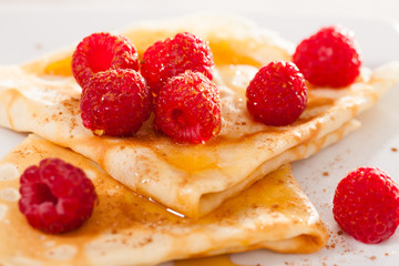 delicious  pancakes with fresh raspberries and honey