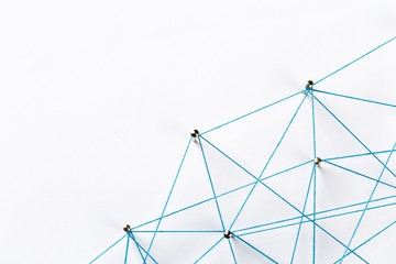 A large grid of pins connected with string. Communication, technology, network concept. Network...