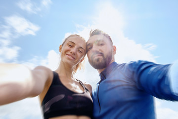 Couple photographing themselves while hiking in summer