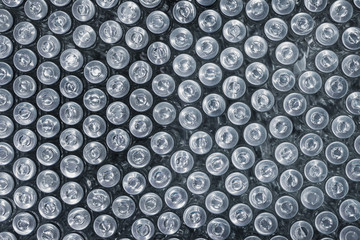 Many drug vials closed with an aluminum cap. View vertically from top to bottom