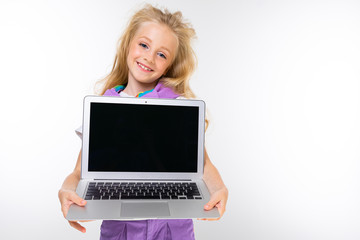 Fototapeta premium portrait of a beautiful schoolgirl with a beautiful haircut on a white isolated background with a laptop screen forward