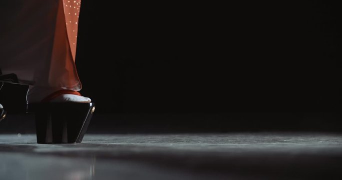 Japanese geisha in traditional kitsune costume and on geta sandals walking on stage while performing a dance - culture concept low angle close up 4k footage