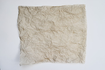 Obraz premium A piece of textured crumpled paper on a light background.