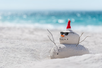 Christmas Sandy Snowman on a beautiful sand beach - Christmas symbol of countries where the weather is always warm