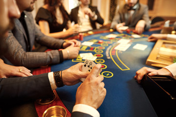 People play poker at the table in the casino.