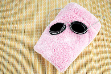 Safety glasses for the solarium and a pink soft cloth