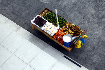 Fruit cart by a sidewalk
