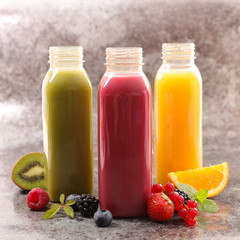 bottle of fruit juice with orange, kiwi and berry fruit