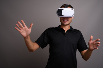 Portrait of handsome man using virtual reality headset