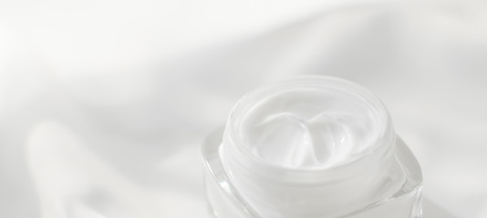 Face cream moisturizer jar on silk background, moisturizing skin care lotion and lifting emulsion,...