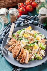 Healthy caesar salad with chicken, eggs and croutons
