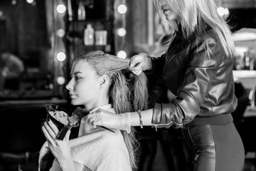 Keratin straightening, smoothing, hair colouring and treatment. Professional female beautician...