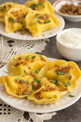 Yellow dumplings with turmeric, fried onions and parsley