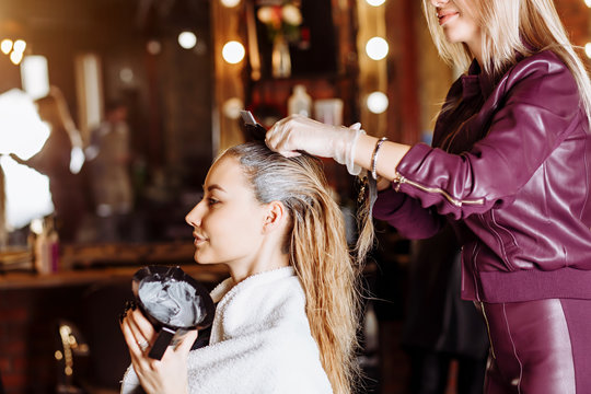 Beautiful woman in hair salon