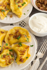 Yellow dumplings with turmeric, fried onions and parsley