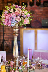 Large flower vase on the festive table.
