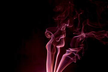 Obraz premium Red smoke on a black background.