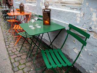Colorful seating in Copenhagen street cafe with lantern