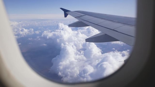 Amazing aerial landscape as seen through porthole of flying airplane. Real time full hd video footage.
