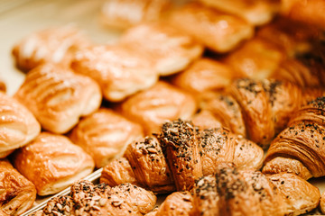 Closeup photo of gold croissants on the conunter in bakery