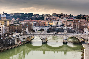 Fototapeta premium Riverfront view on Rome and stones bridges on Tiber river in Rome. Italy