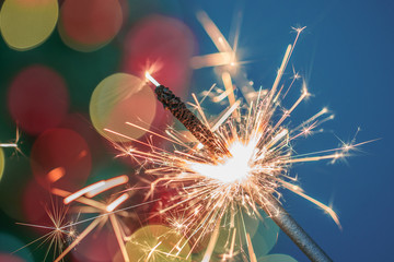 Close-up of holiday Christmas sparkler on dark background